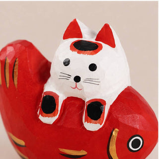 Cat Laying on Fish Figurine