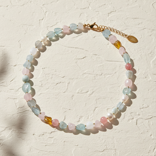 Multicolored beaded bracelet on a textured beige background