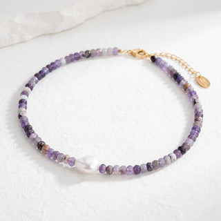 Necklace with purple beads on a white background