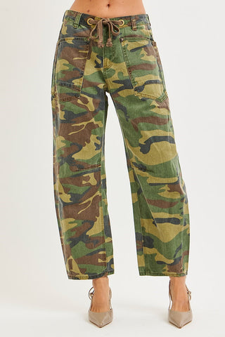 A person wearing camouflage wide-leg cropped jeans with a drawstring waist, shown from the waist down against a plain light background.