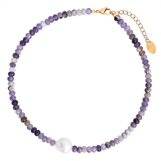 Multi-shade purple beaded necklace with a gold clasp on a white background