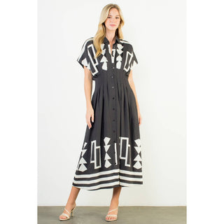 Woman wearing a black dress with white geometric patterns on a white background