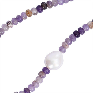 Necklace with purple beads and a large white pearl on a white background