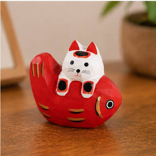 Cat Laying on Fish Figurine