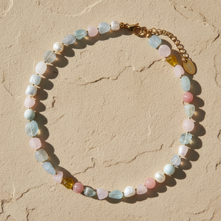 Multicolored beaded bracelet on a beige stone surface