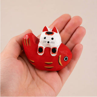 Cat Laying on Fish Figurine