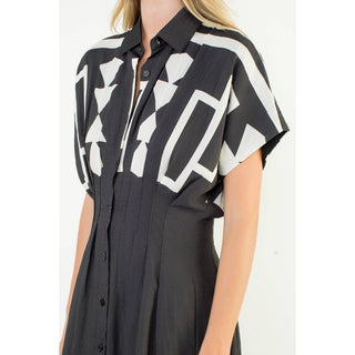 Black and white geometric patterned shirt worn by a person on a white background
