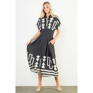 Woman wearing a black and white patterned dress on a white background